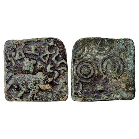 Obv: Elephant with upraised trunk marching to right, Swastika on its back; Brahmi legend …