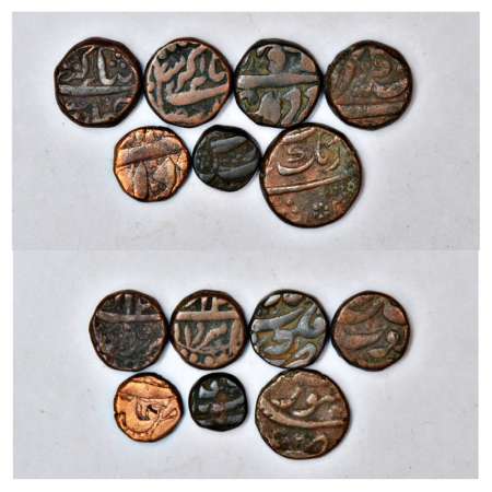 A group of 7 copper coins, 6x Akbar and 1x Aurangzeb, includes ½ and ¼ Dam, Burhanpur, Ber